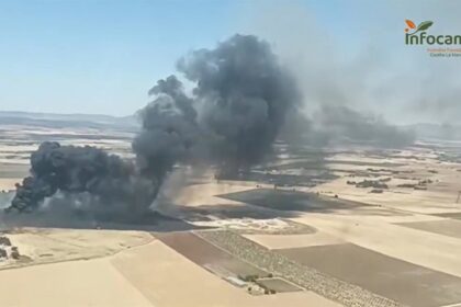 Imagen de un camión de bomberos en una zona de pastos quemada cerca de un punto limpio